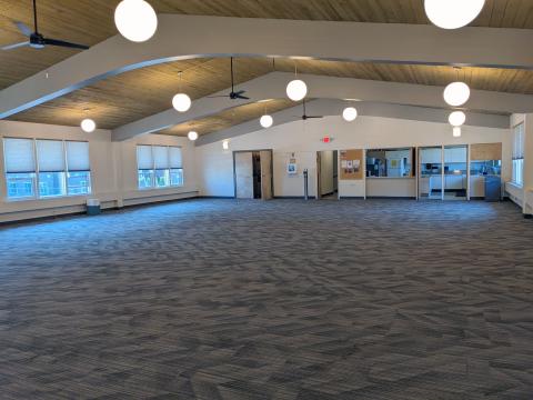 Empty Fellowship Hall space with kitchen on end